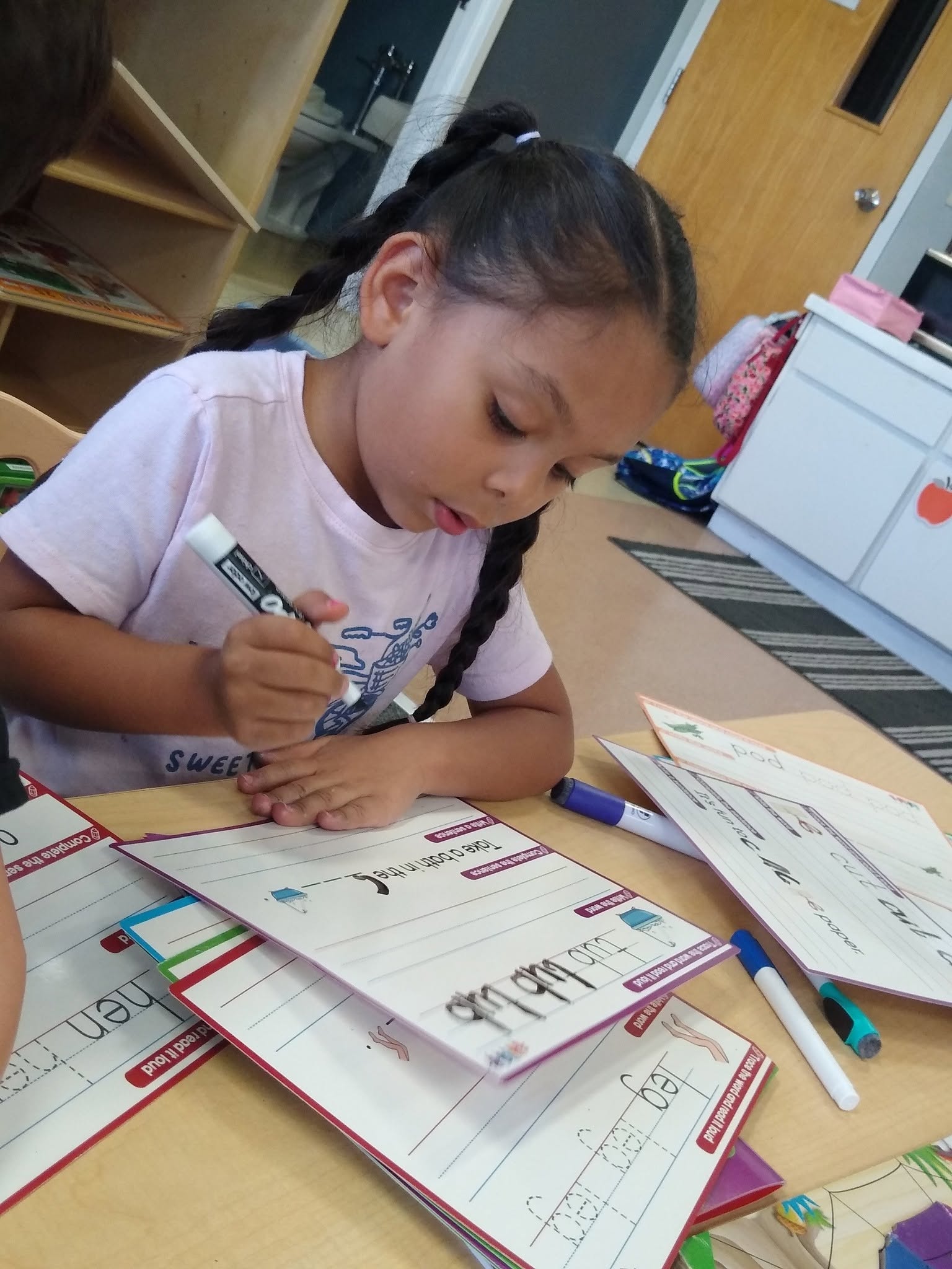 A Little Love's student writing at her desk